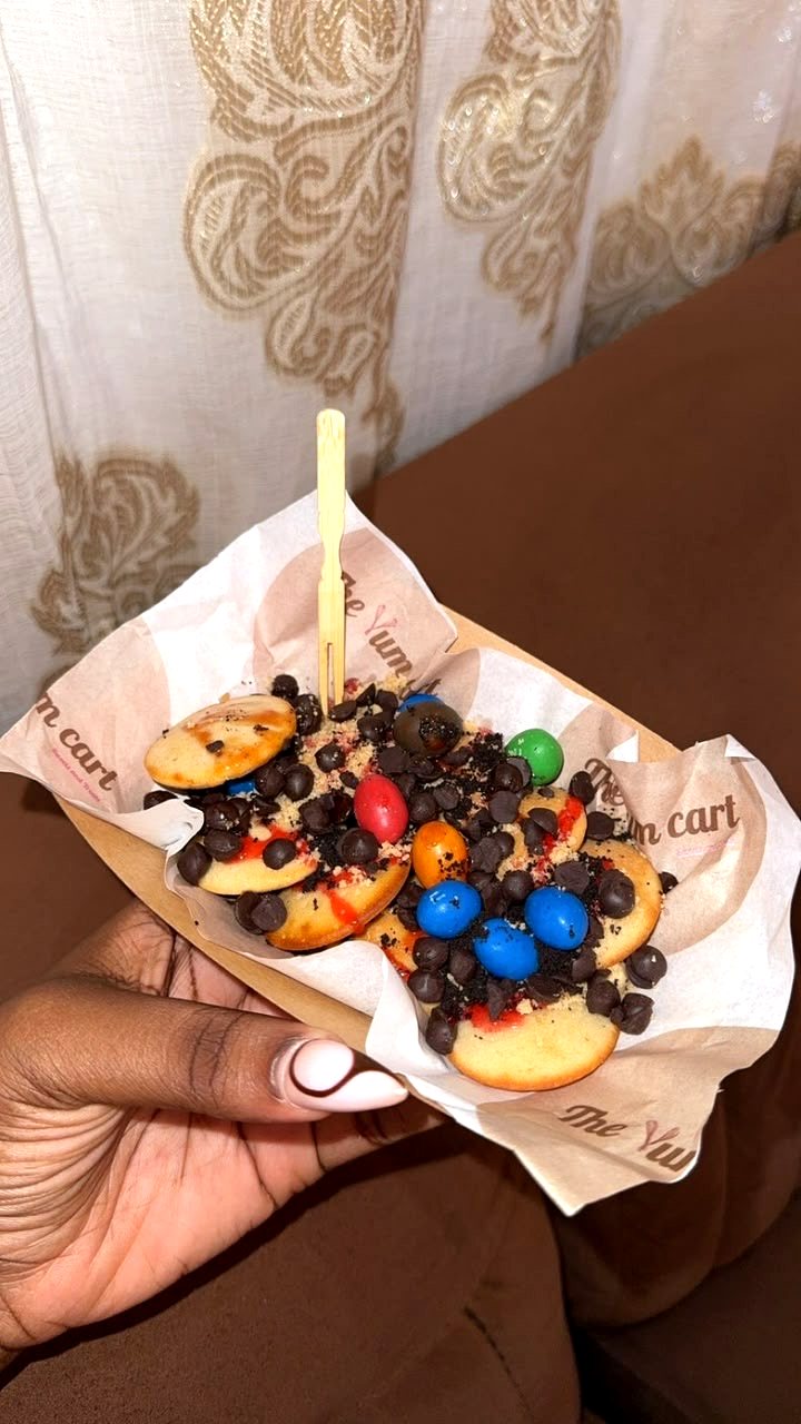 A tray of mini pancakes loaded with chocolate chips and sweets